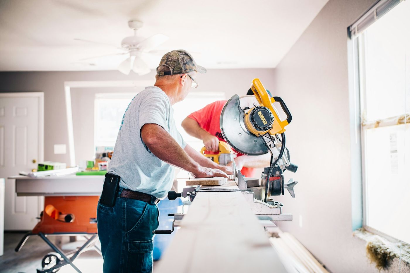 Veritron craftsman carefully measuring and cutting timber on site during a Warsaw renovation project
